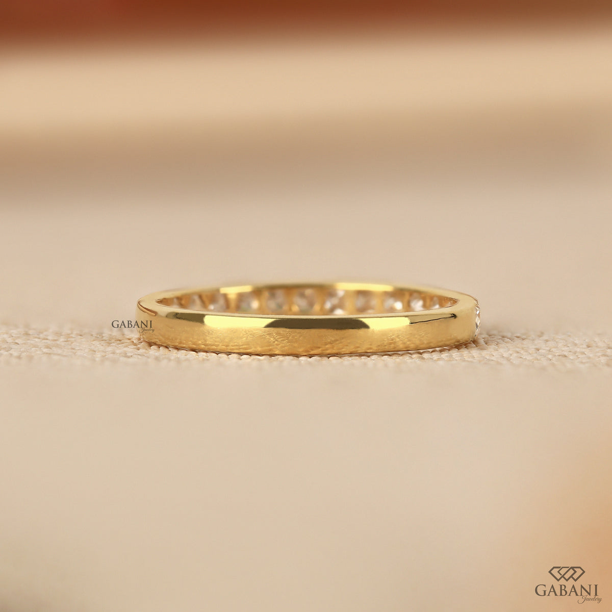 channel set lab grown diamond wedding band featuring square princess cut stones in yellow gold