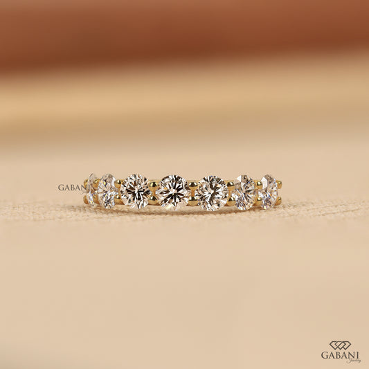7 stone lab grown diamond wedding band with round cut diamonds in a U prong setting crafted in 14k yellow gold