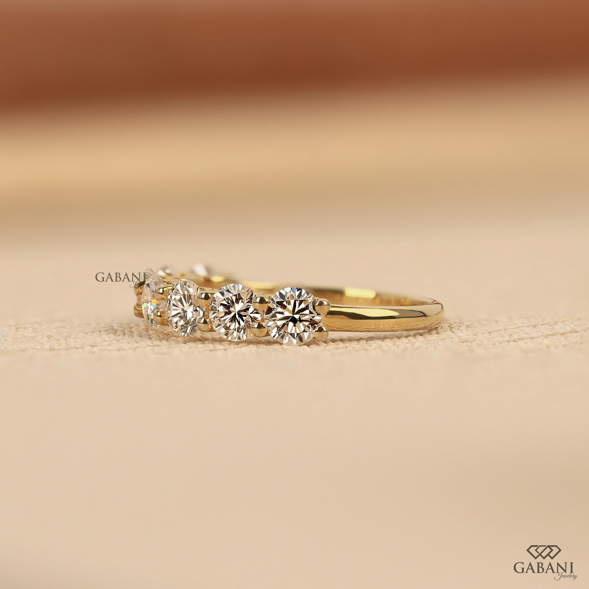 lab grown diamond half eternity band with seven round cut stones set in yellow gold