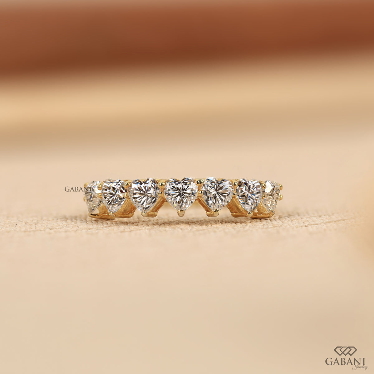 seven stone heart shaped lab grown diamond band in yellow gold