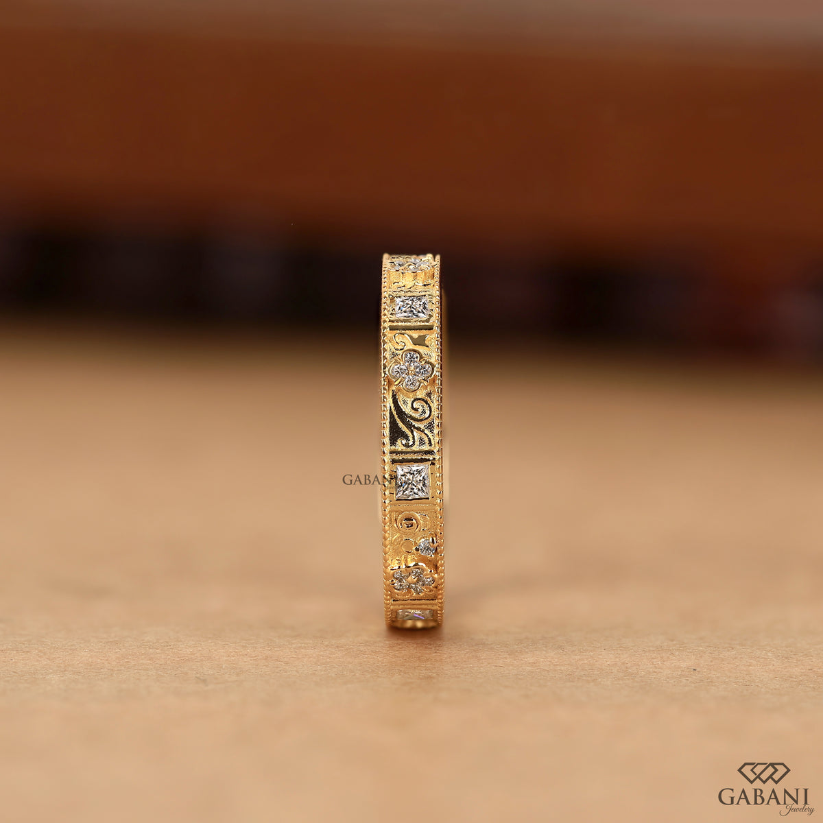 art deco eternity band with princess cut and round lab grown diamonds in yellow gold with milgrain detail
