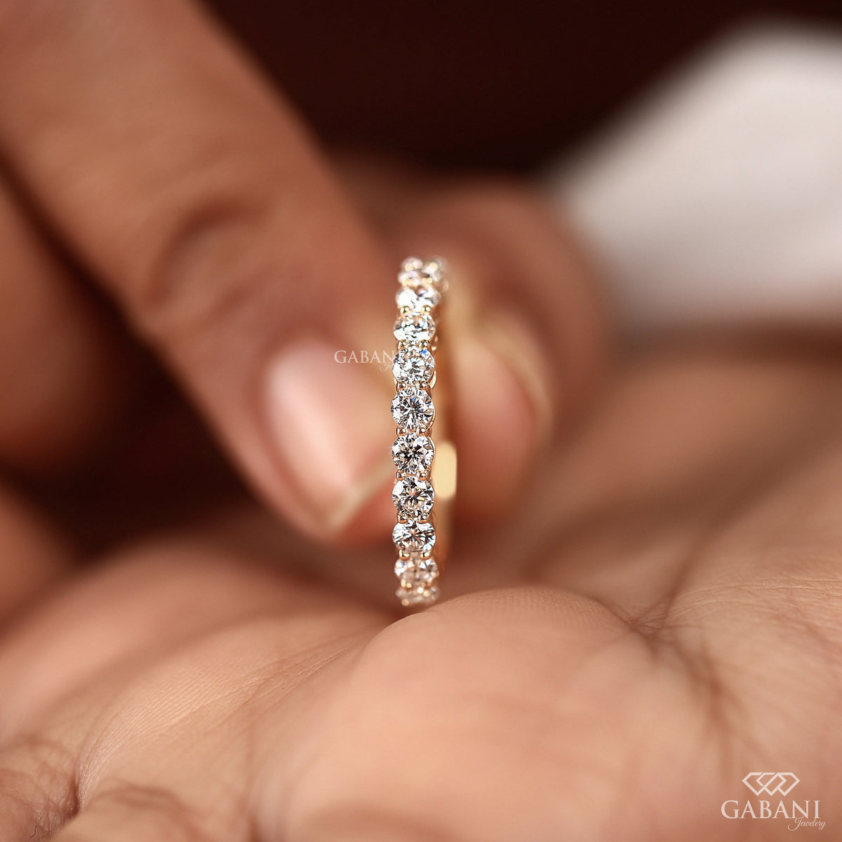 Comfort fit wedding band with round lab grown diamonds in shared prong setting