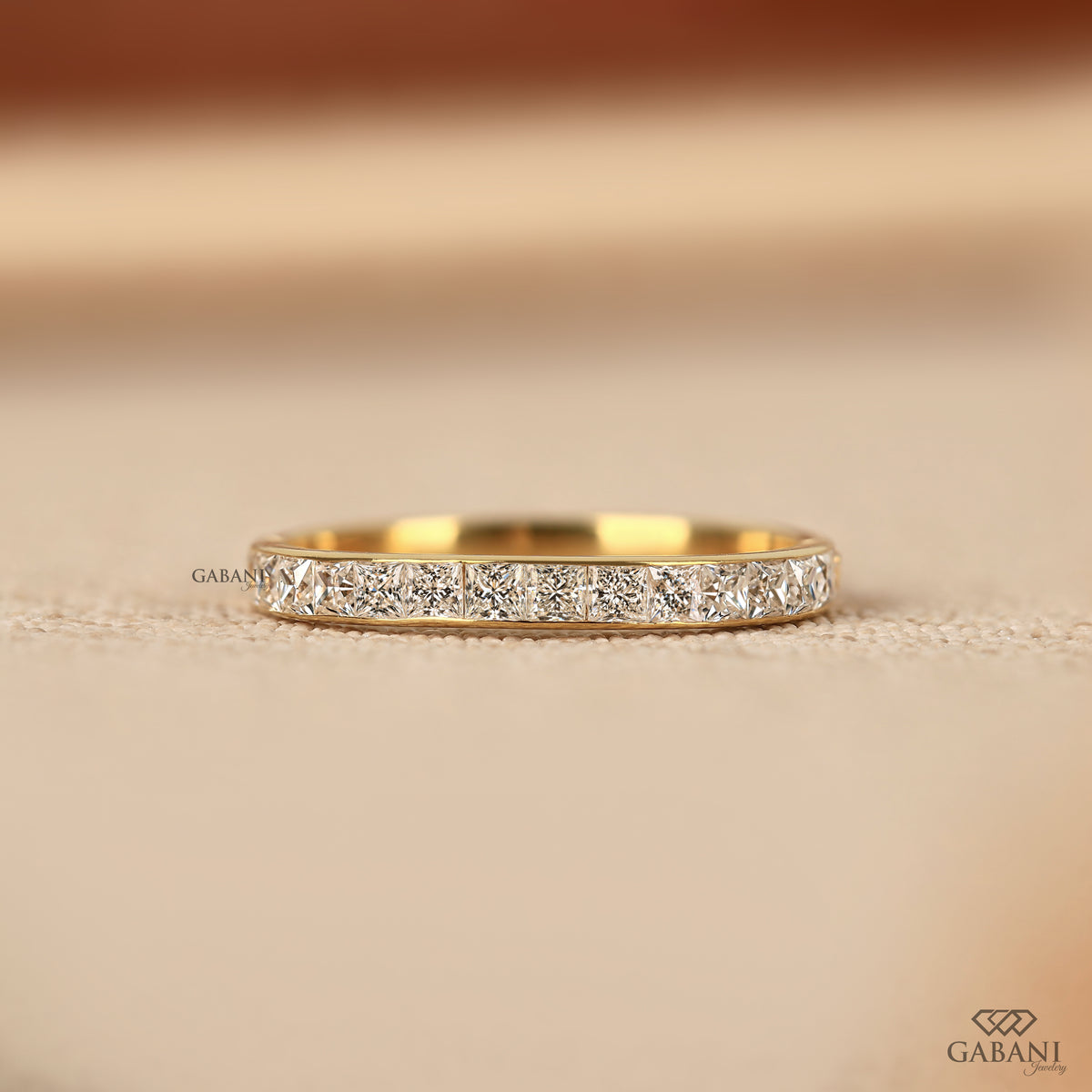 princess cut lab grown diamond wedding band in yellow gold with channel set half eternity design