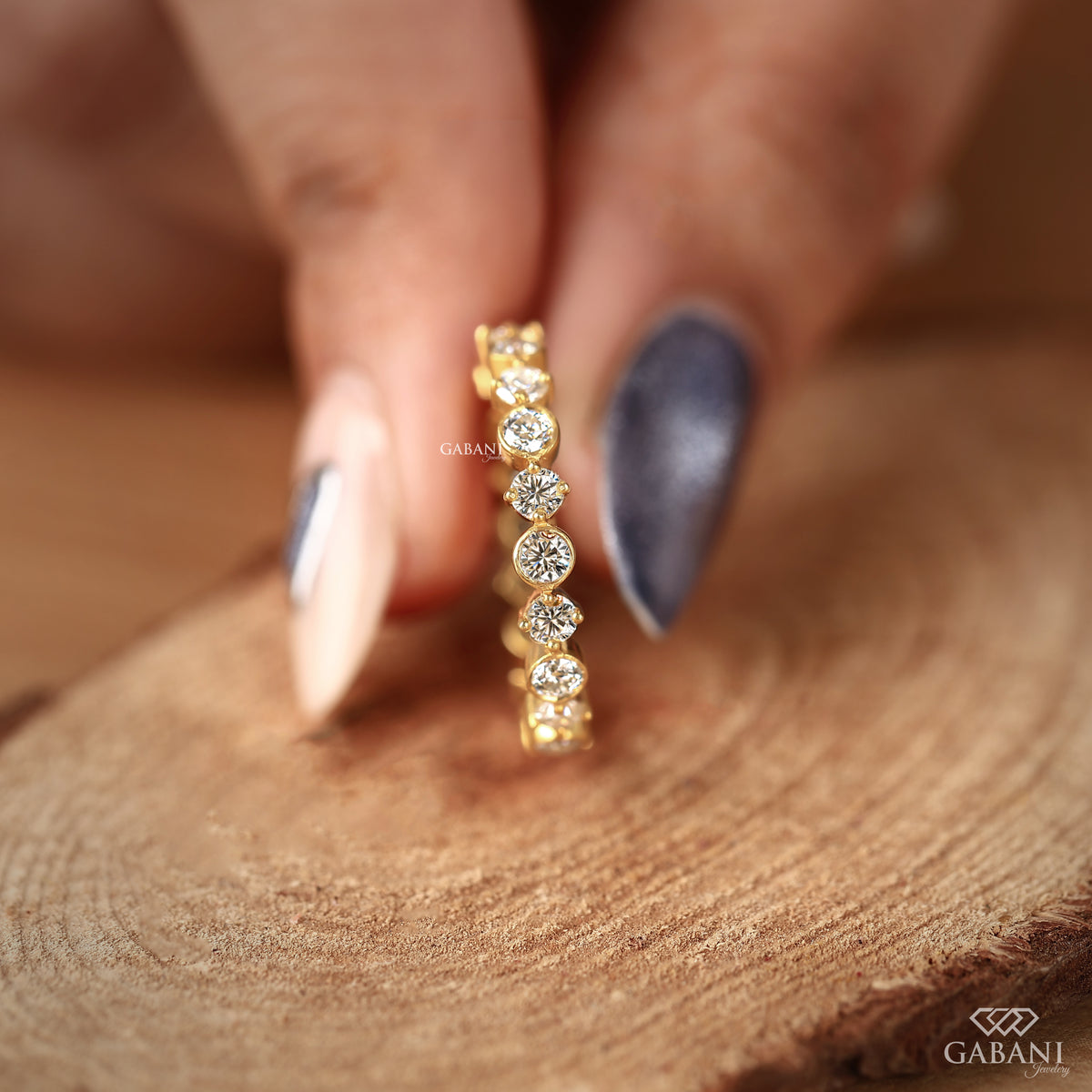 bezel set round diamond wedding band crafted in 14k yellow gold with continuous eternity layout