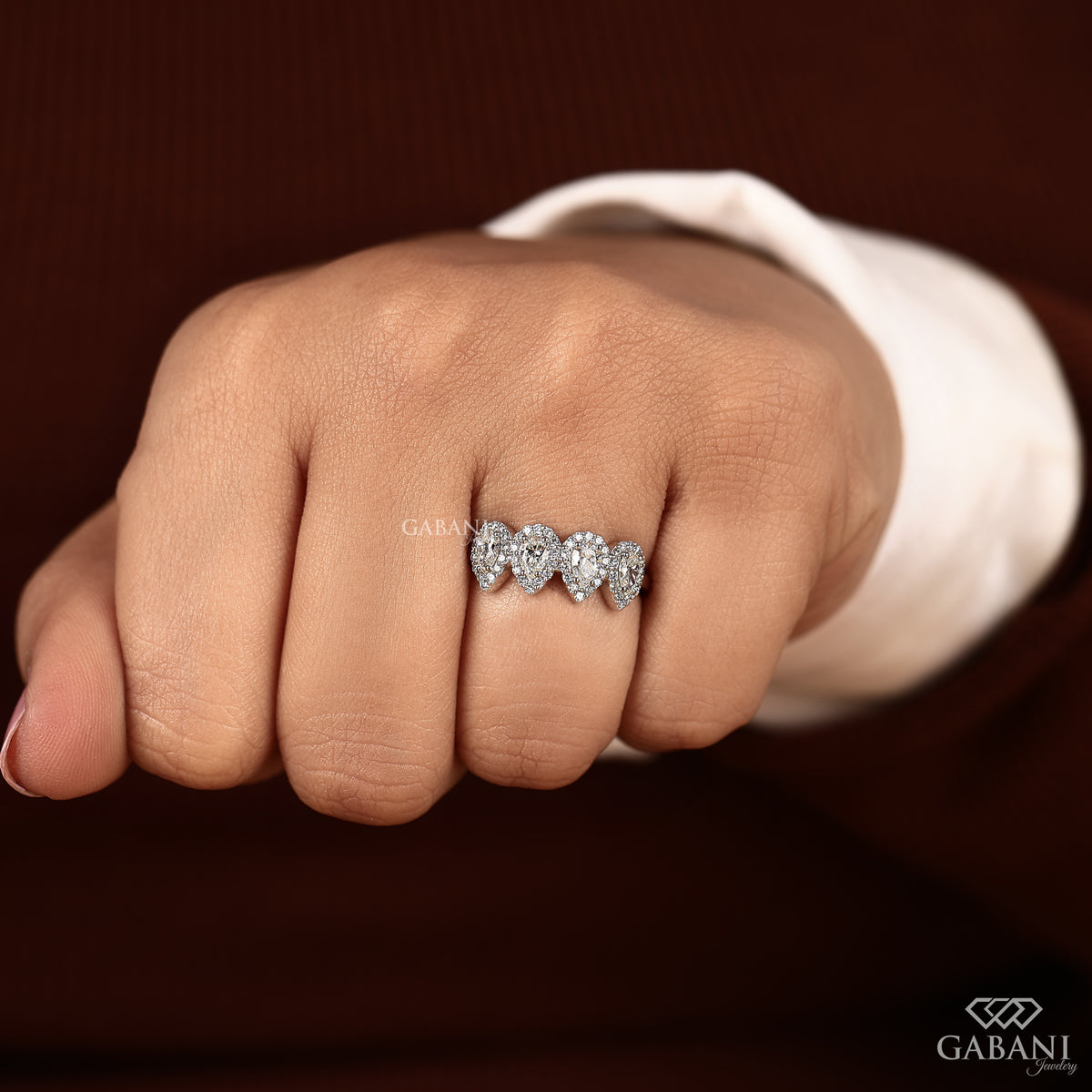 halo style wedding band with four pear diamonds