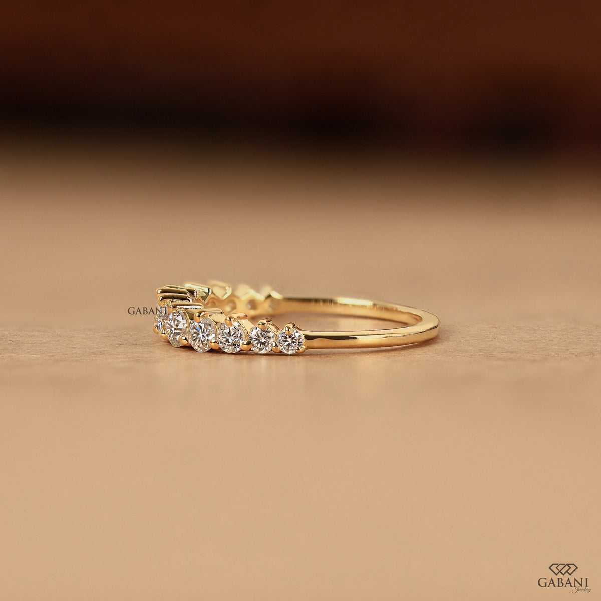 minimal yellow gold band with small round lab diamonds in half eternity design
