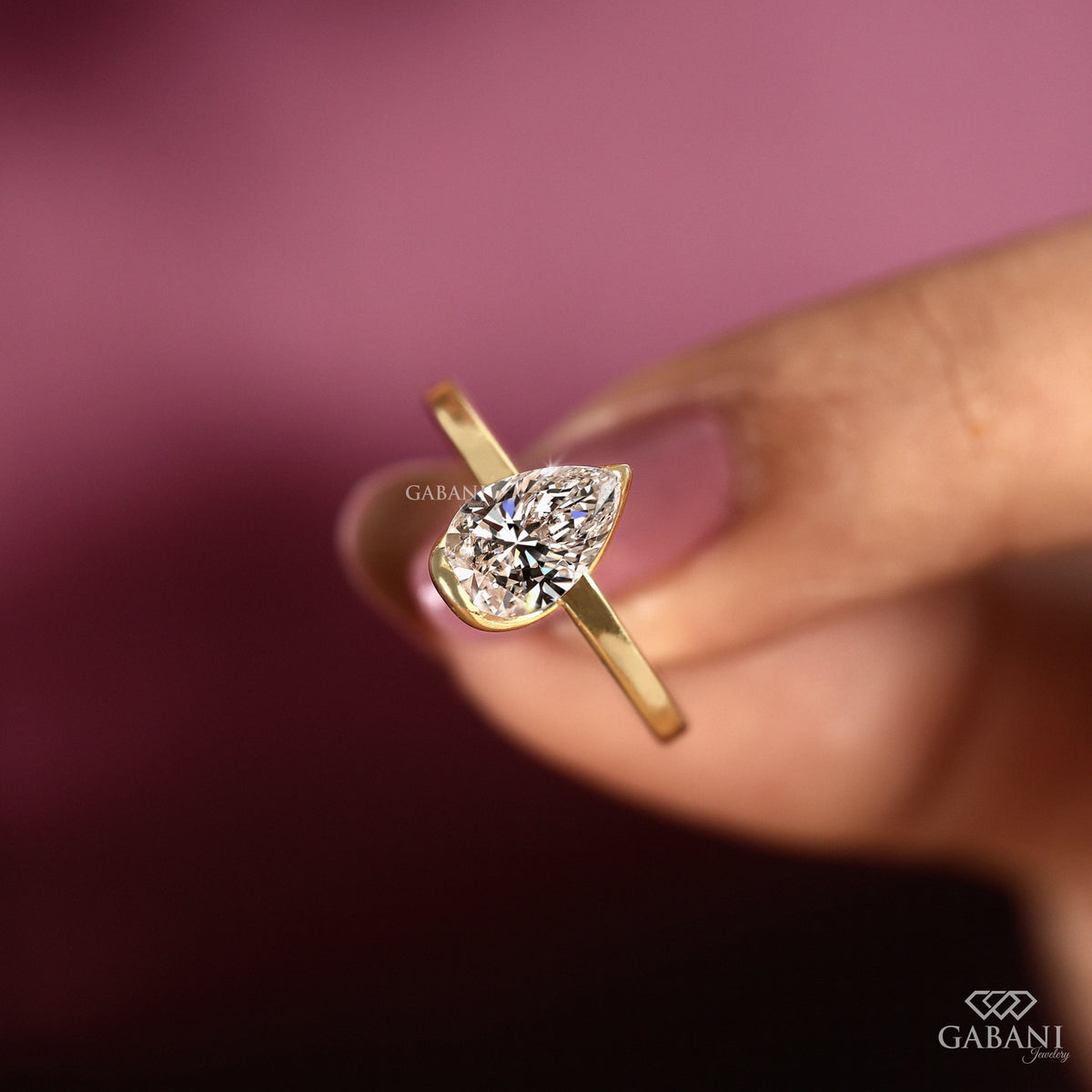 Pear shape lab grown diamond engagement ring in yellow gold
