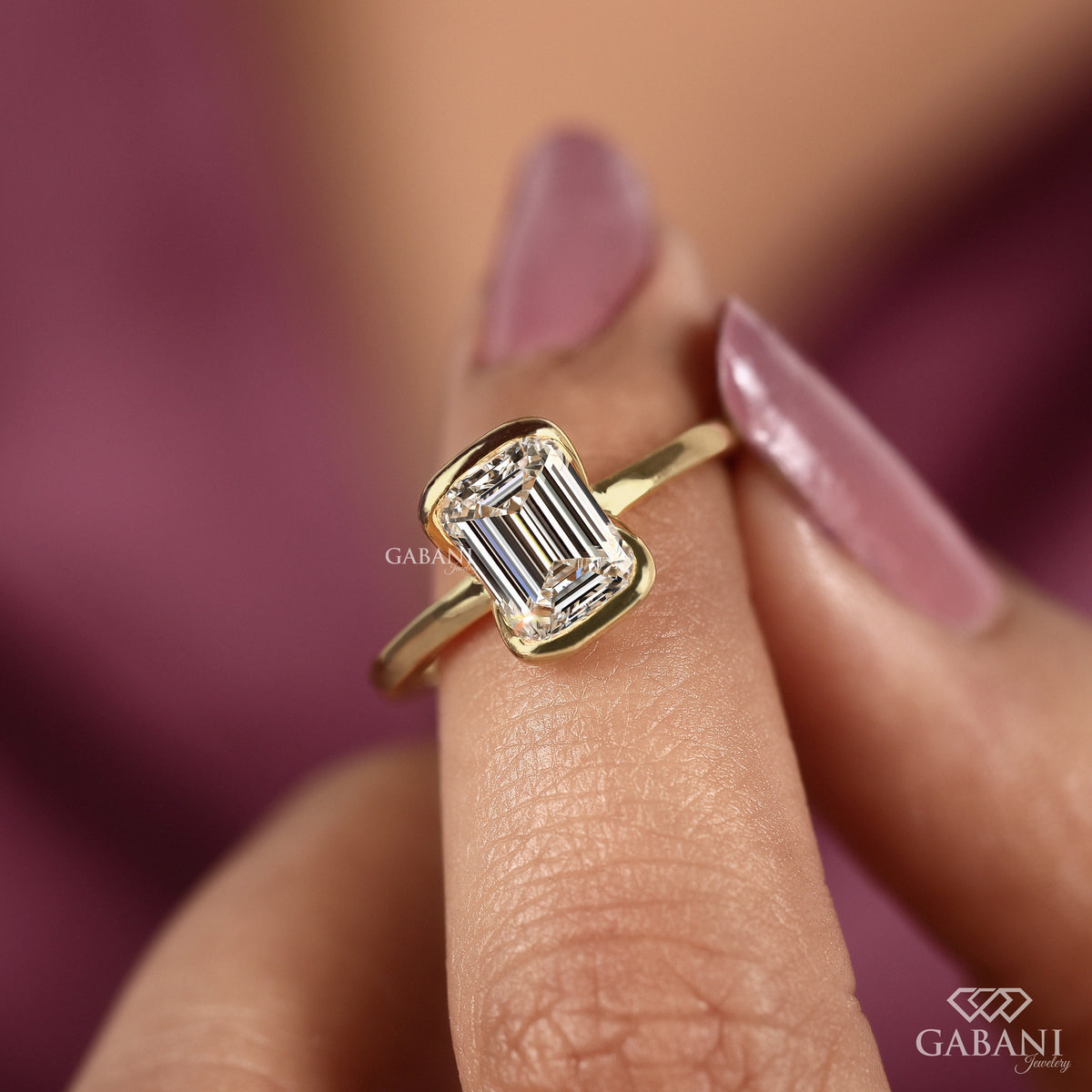 emerald cut lab grown diamond ring with minimalist half bezel yellow gold band
