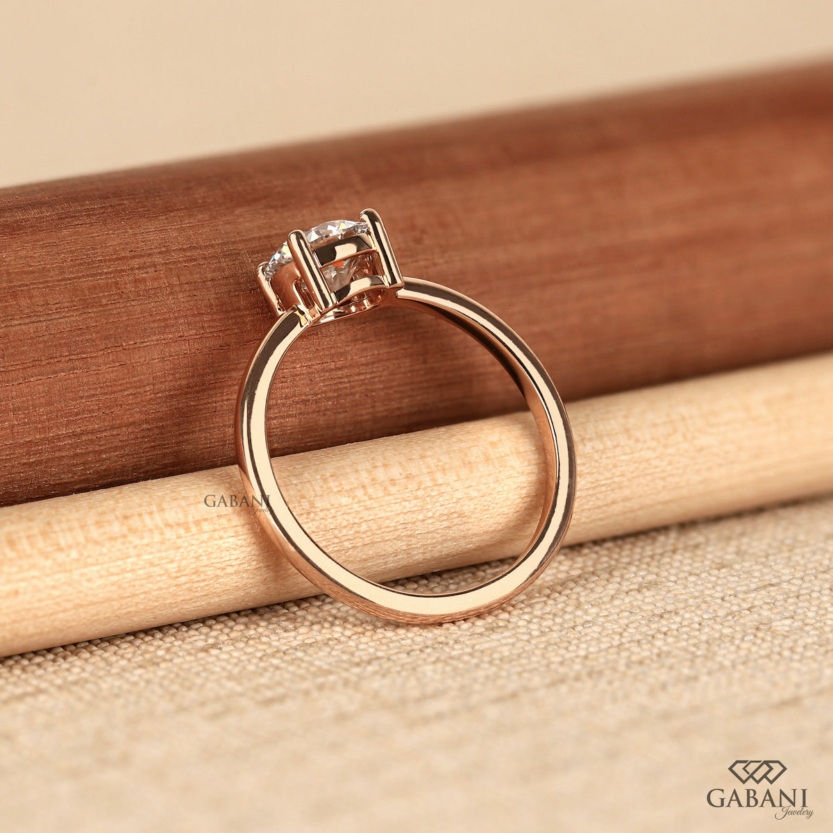 round lab grown diamond solitaire ring with polished 14k rose gold band
