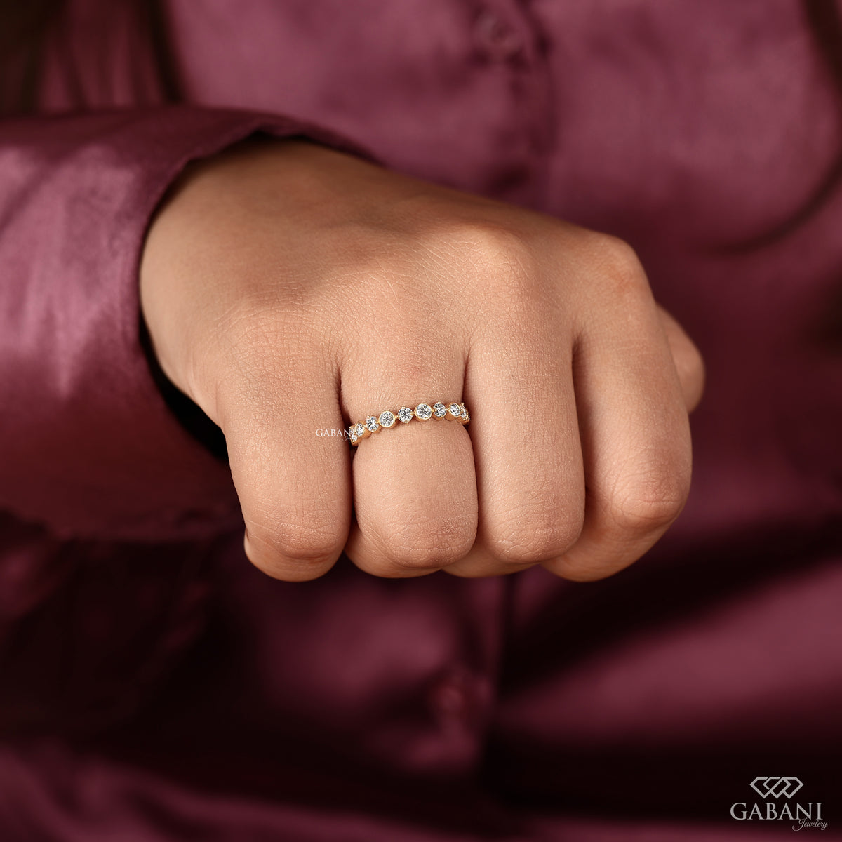 bezel set round diamond band with full eternity design in smooth polished yellow gold
