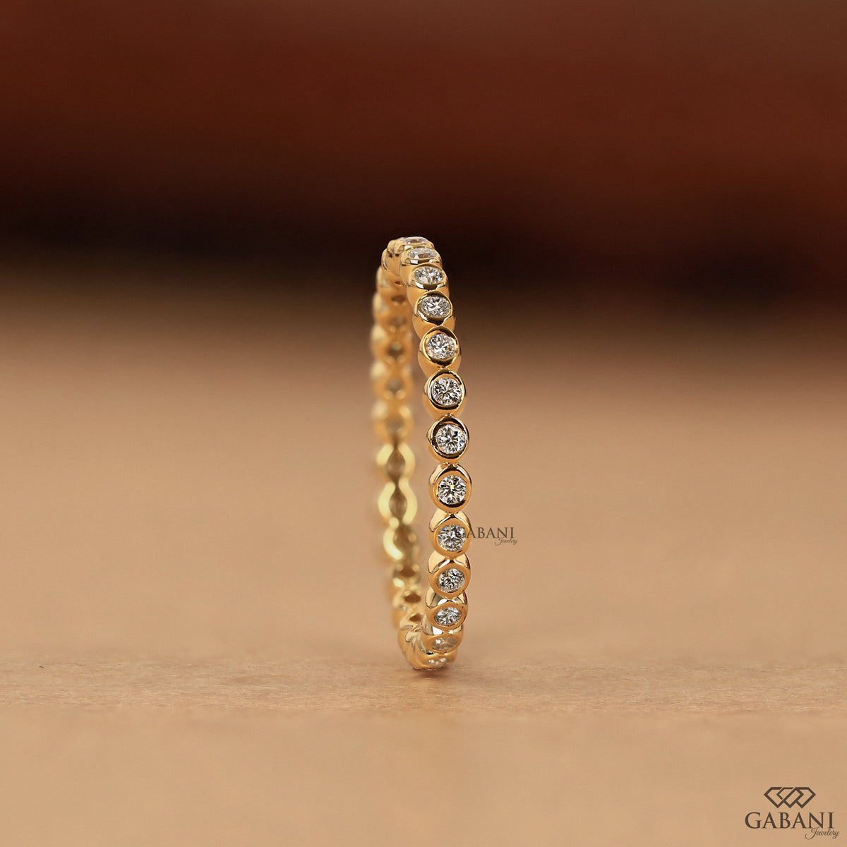 lab grown diamond bezel set eternity band in gold, delicate thin wedding band for everyday use