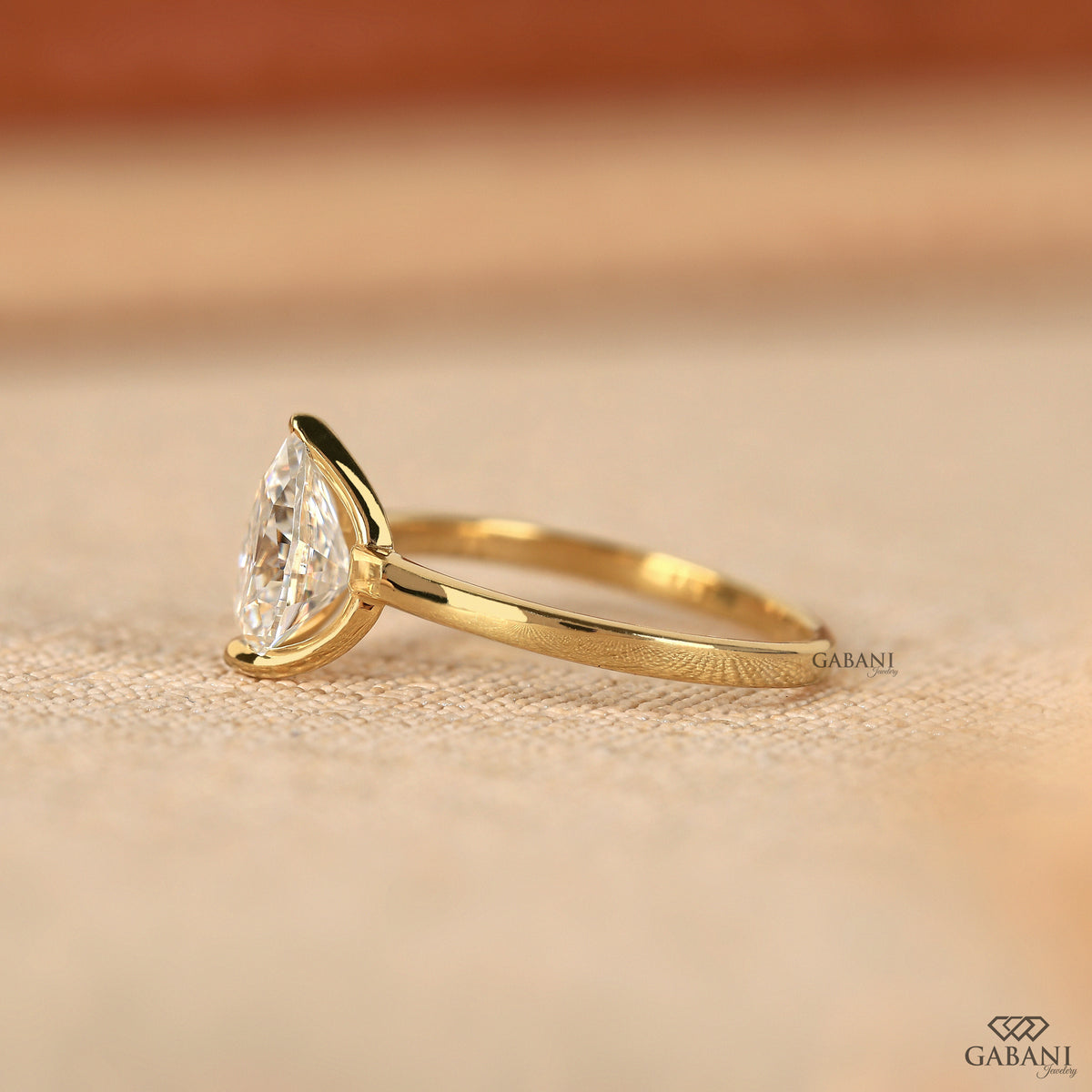 Yellow gold solitaire ring with pear cut lab grown diamond
