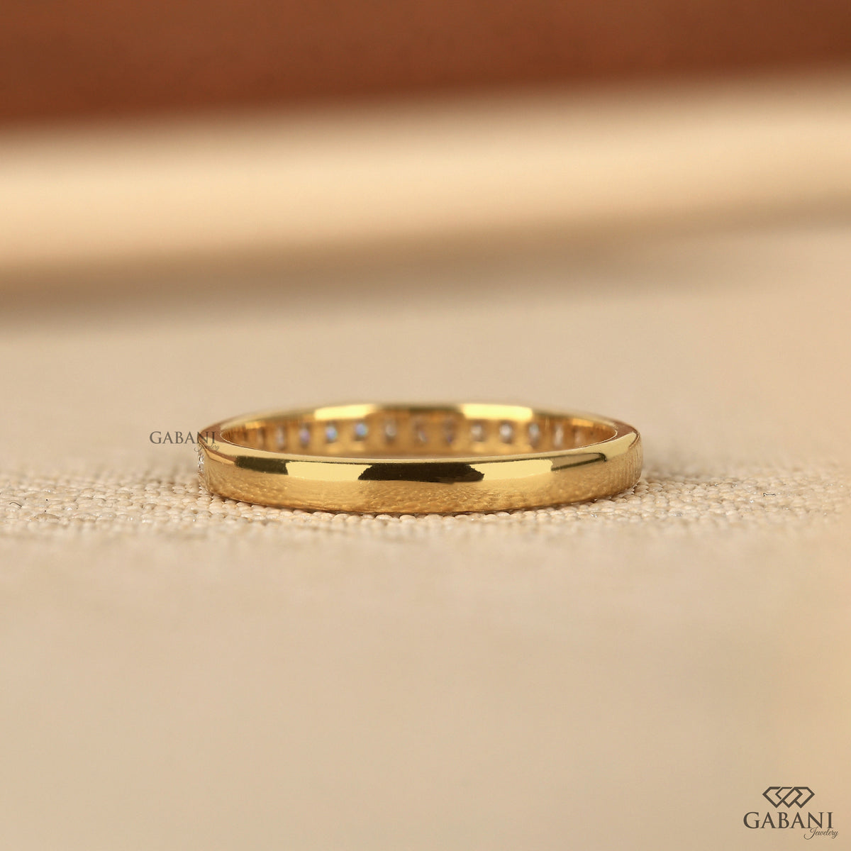dainty half eternity band with channel set lab grown diamonds in yellow gold