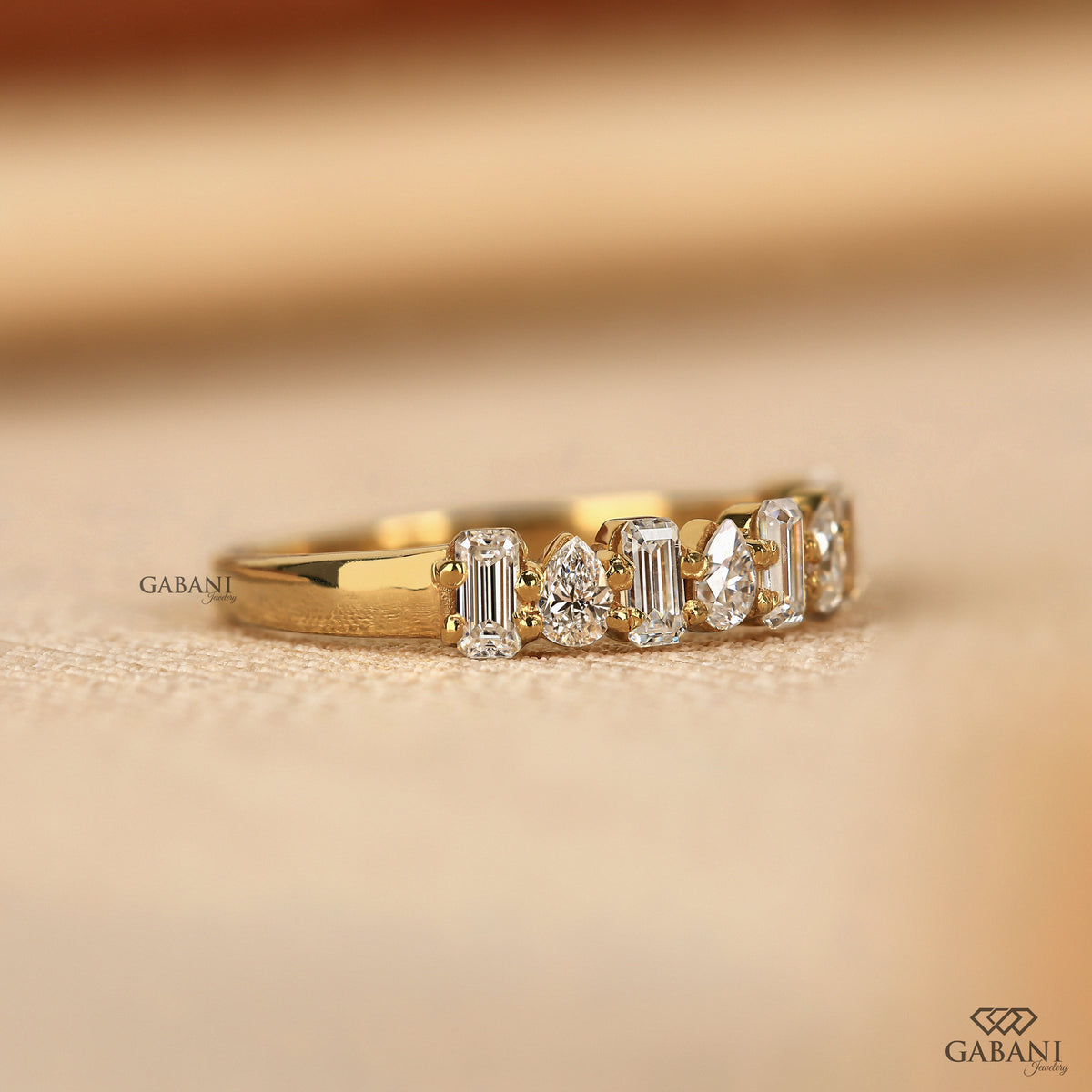 minimal diamond wedding band with mixed emerald and pear cut lab grown diamonds