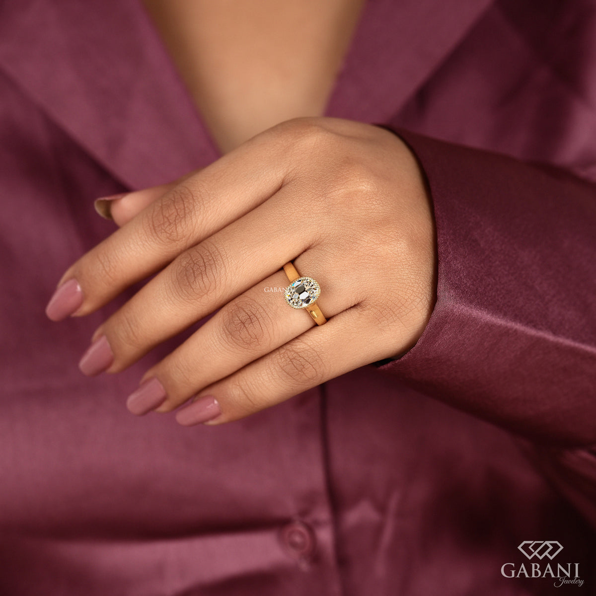 Cushion old mine cut lab grown diamond ring in a refined bezel set solitaire design