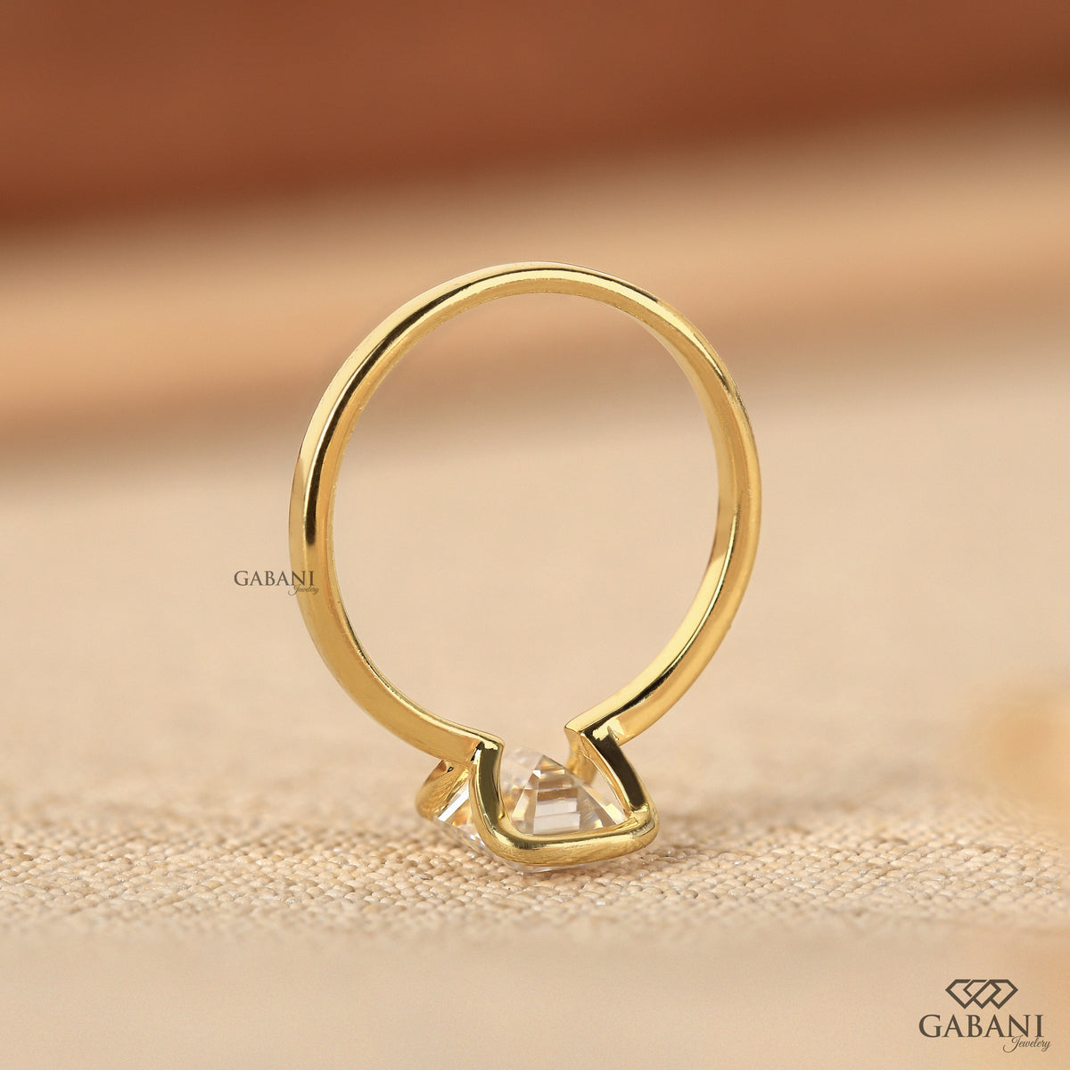 modern emerald cut lab grown diamond ring in yellow gold half bezel style