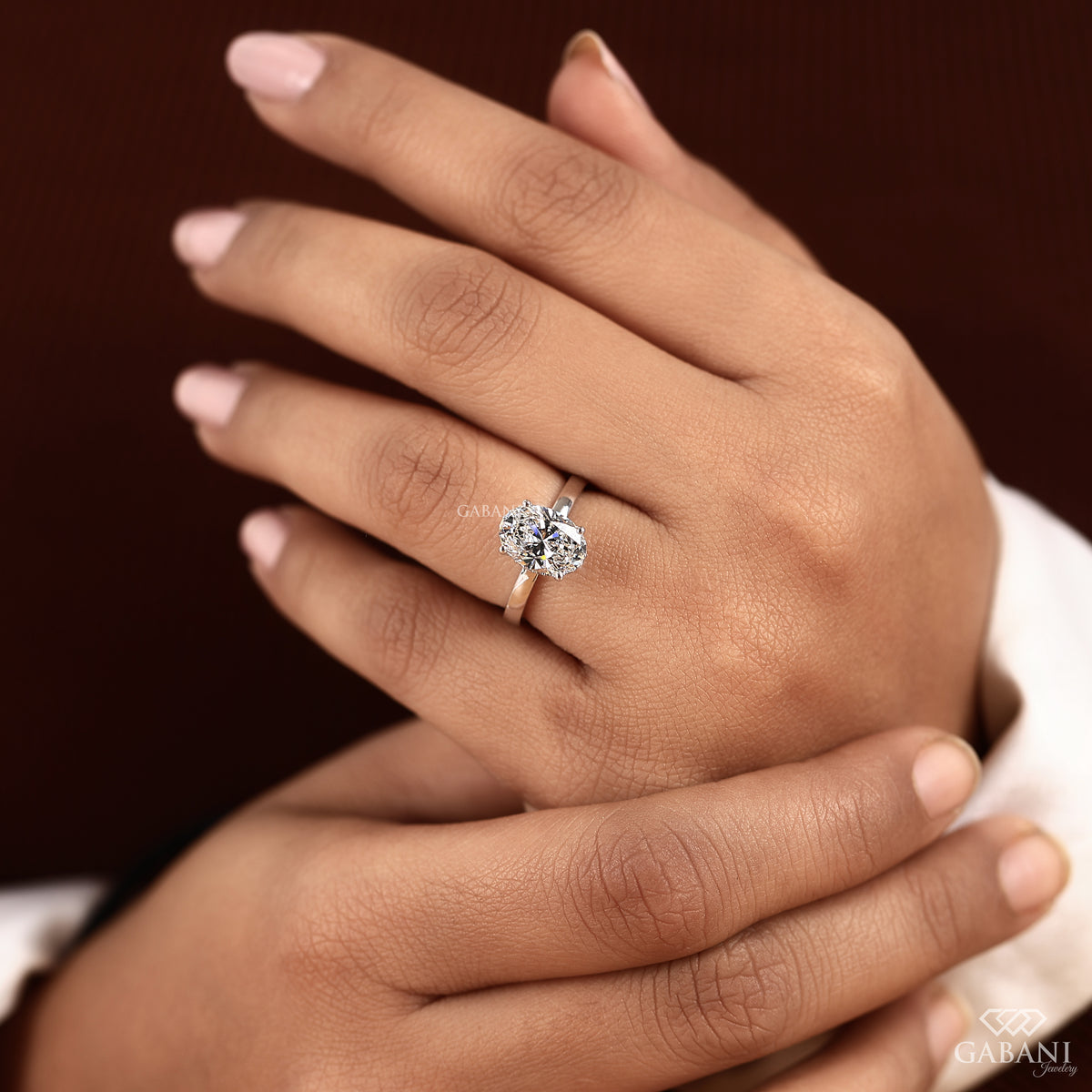 white gold oval diamond ring with hidden halo and slim flat shank