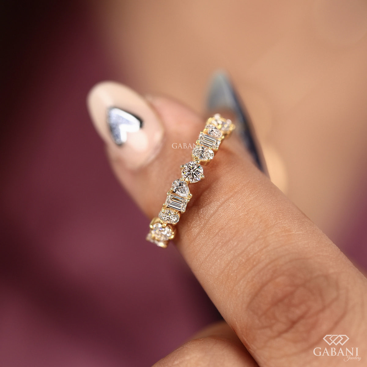 Lab grown diamond band with round pear emerald and oval stones in a modern style