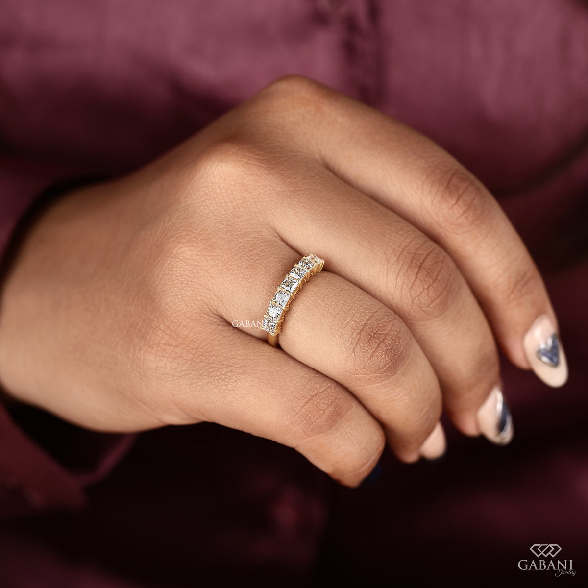 Princess cut lab grown diamond band with seven stones in smooth yellow gold
