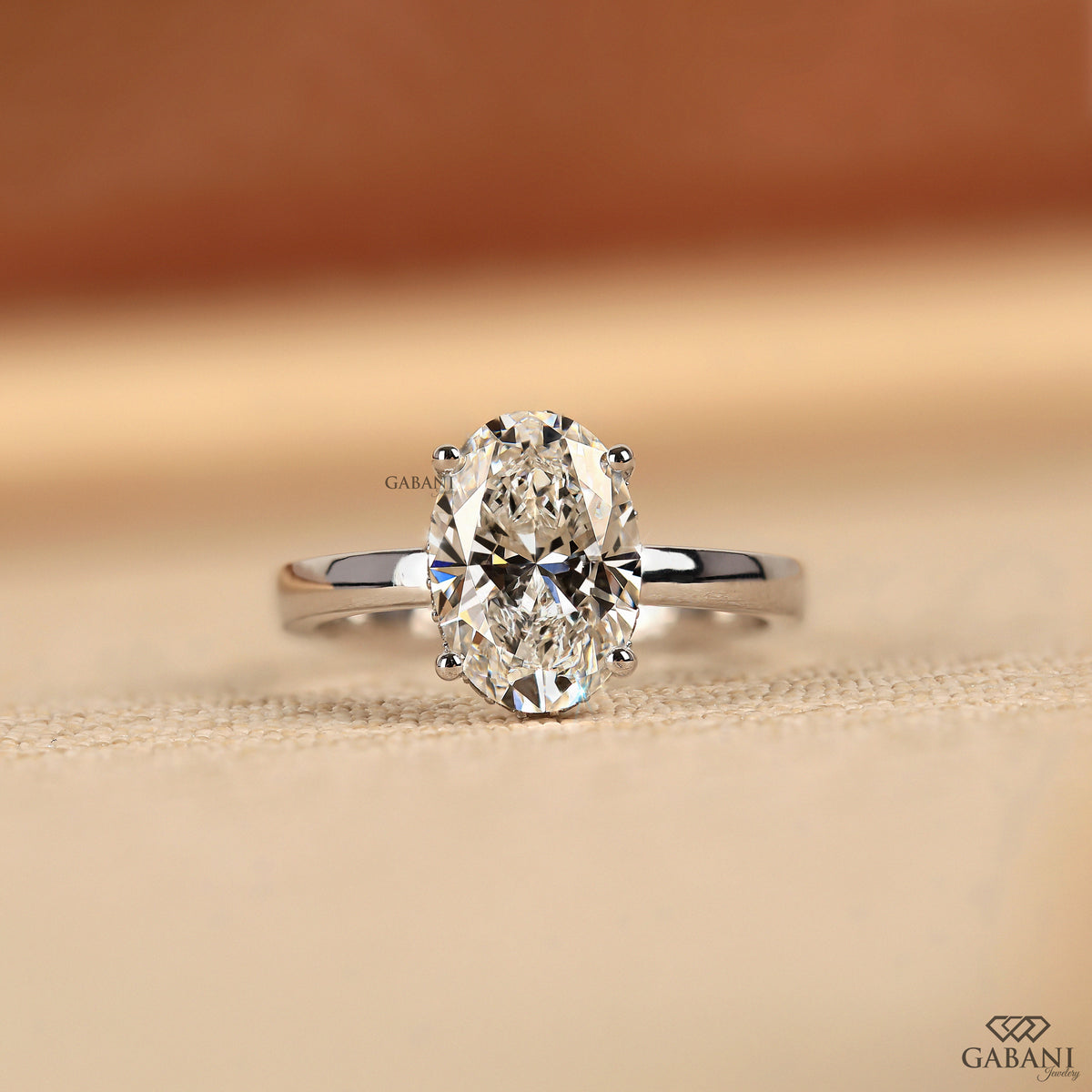 oval cut lab grown diamond solitaire ring with hidden halo in white gold flat band