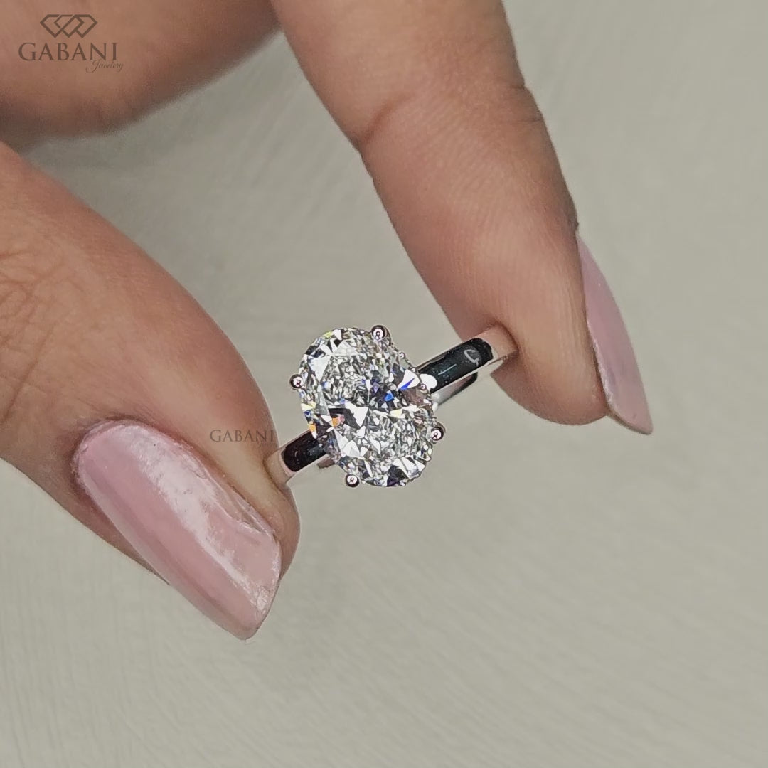 hidden halo oval lab grown diamond ring set in white gold basket setting