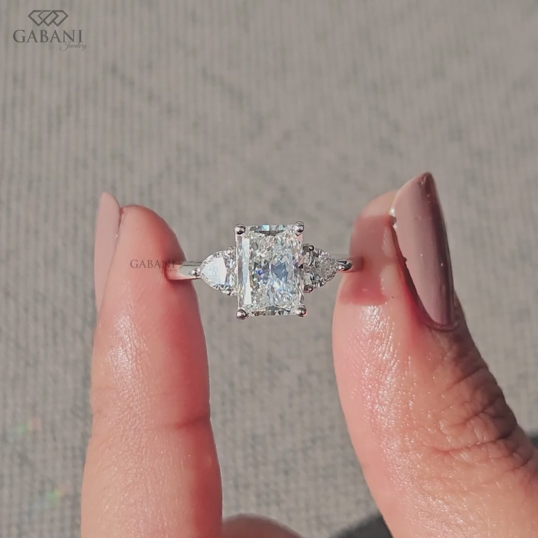 Radiant cut IGI certified lab grown diamond ring with heart accents in white gold three stone setting