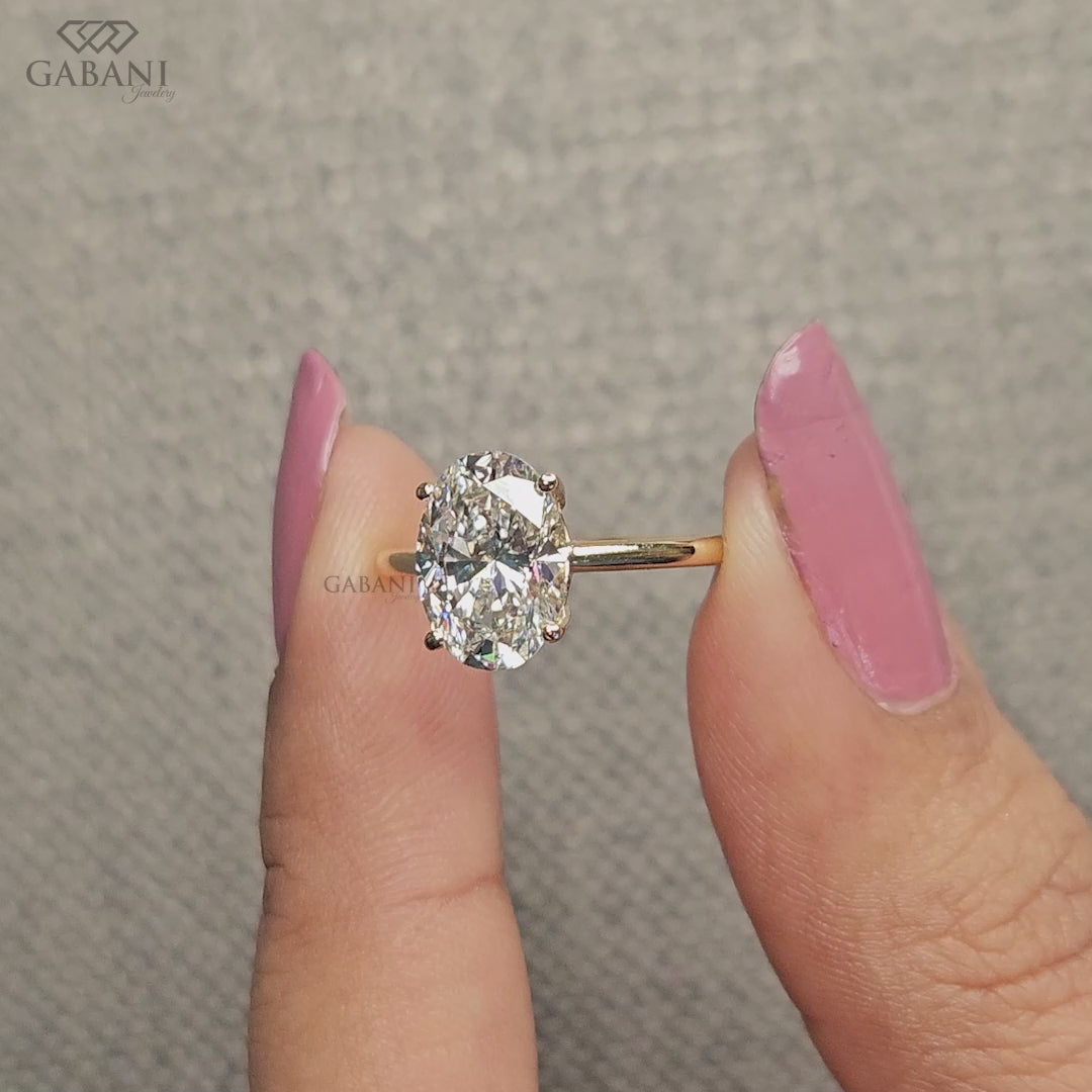 oval lab grown diamond solitaire ring crafted in solid 14k yellow gold with a clean pipe shank