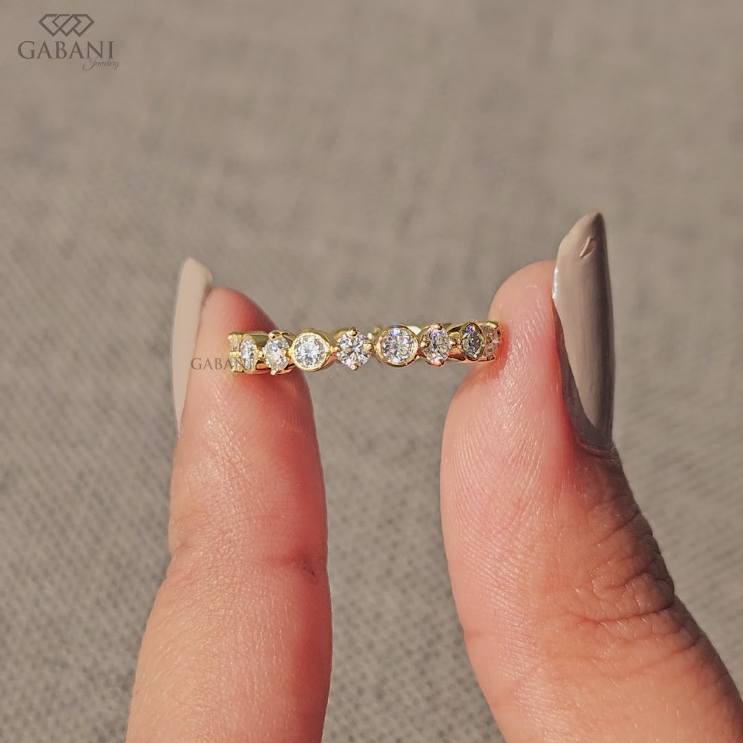 round lab grown diamond eternity band featuring bezel and single prong setting in 14k yellow gold