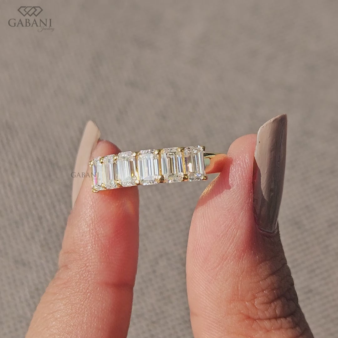 Seven stone emerald cut lab grown diamond band in yellow gold