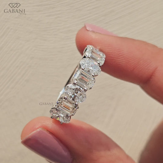 white gold wedding band with alternating emerald and oval cut lab grown diamonds