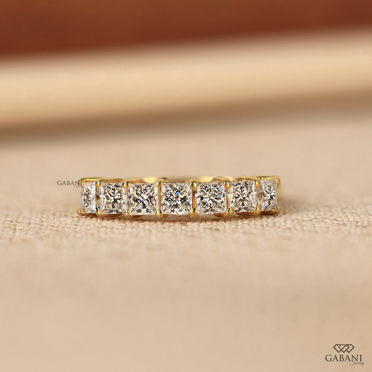 7 stone princess cut lab grown diamond half eternity band in yellow gold
