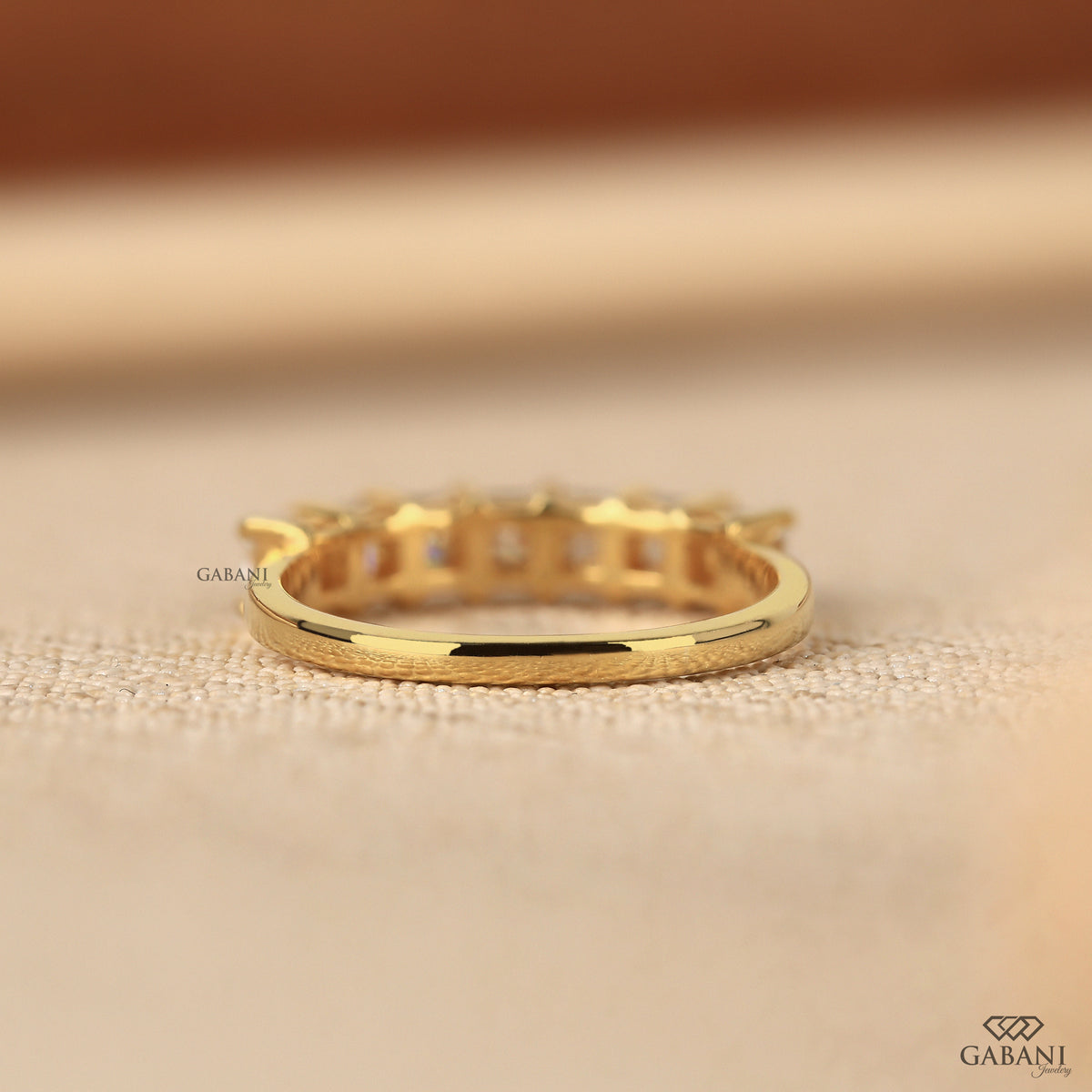 Yellow gold band with seven stone princess cut lab grown diamonds
