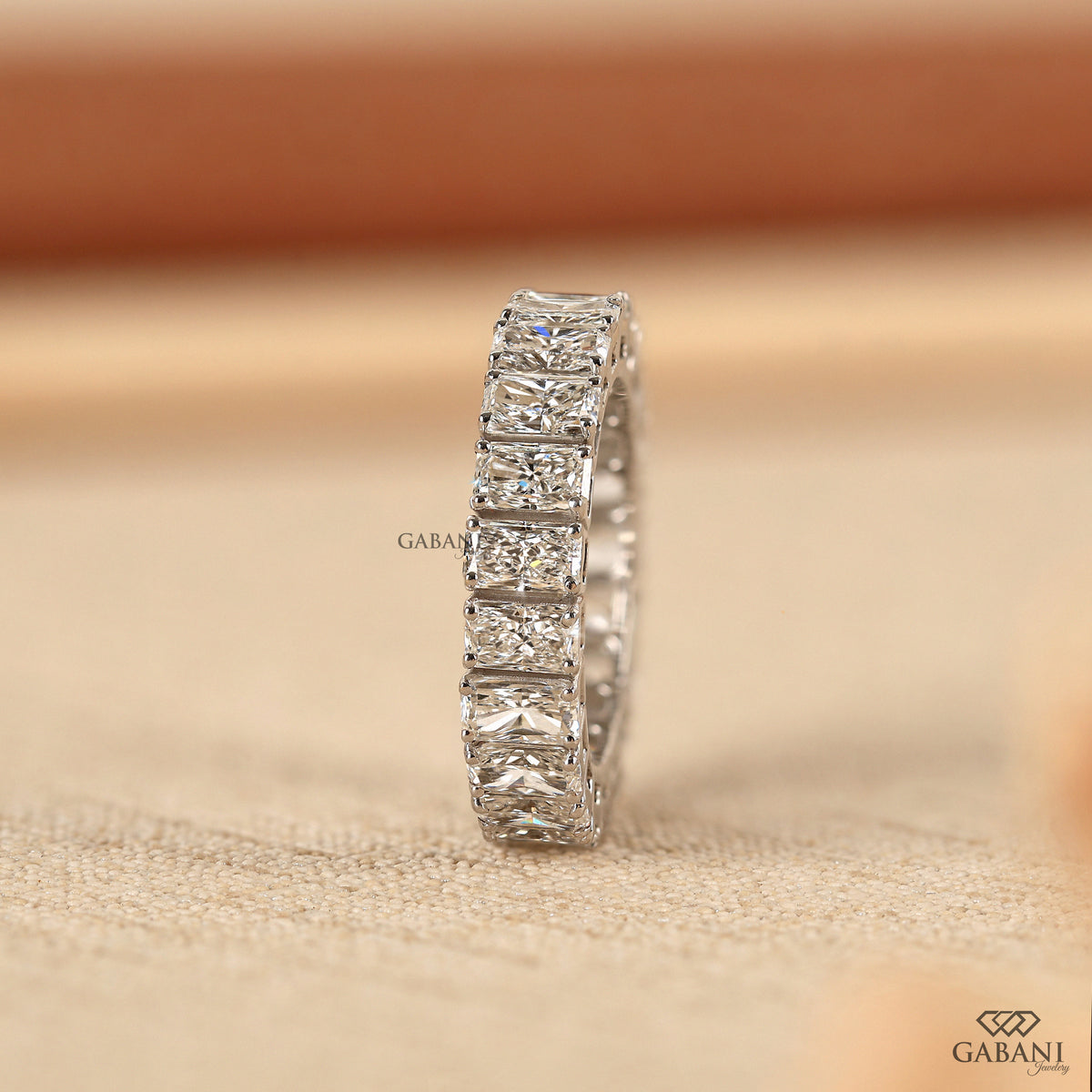 Wide profile white gold band set with radiant cut lab grown diamonds