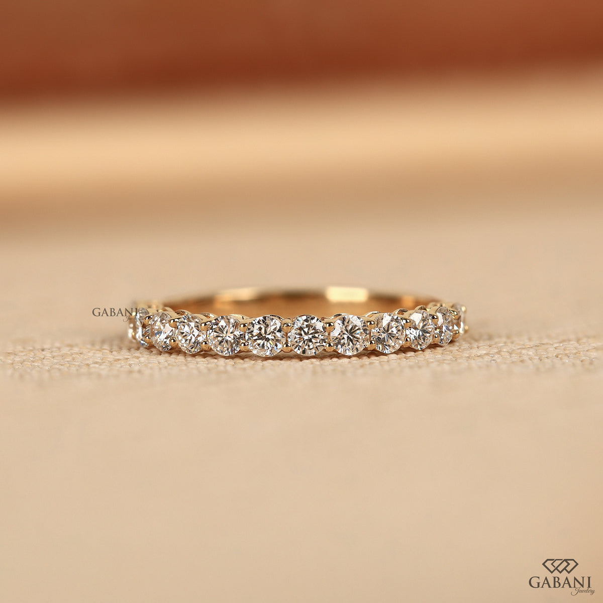 Round lab grown diamond wedding band in white gold with shared prong half eternity style