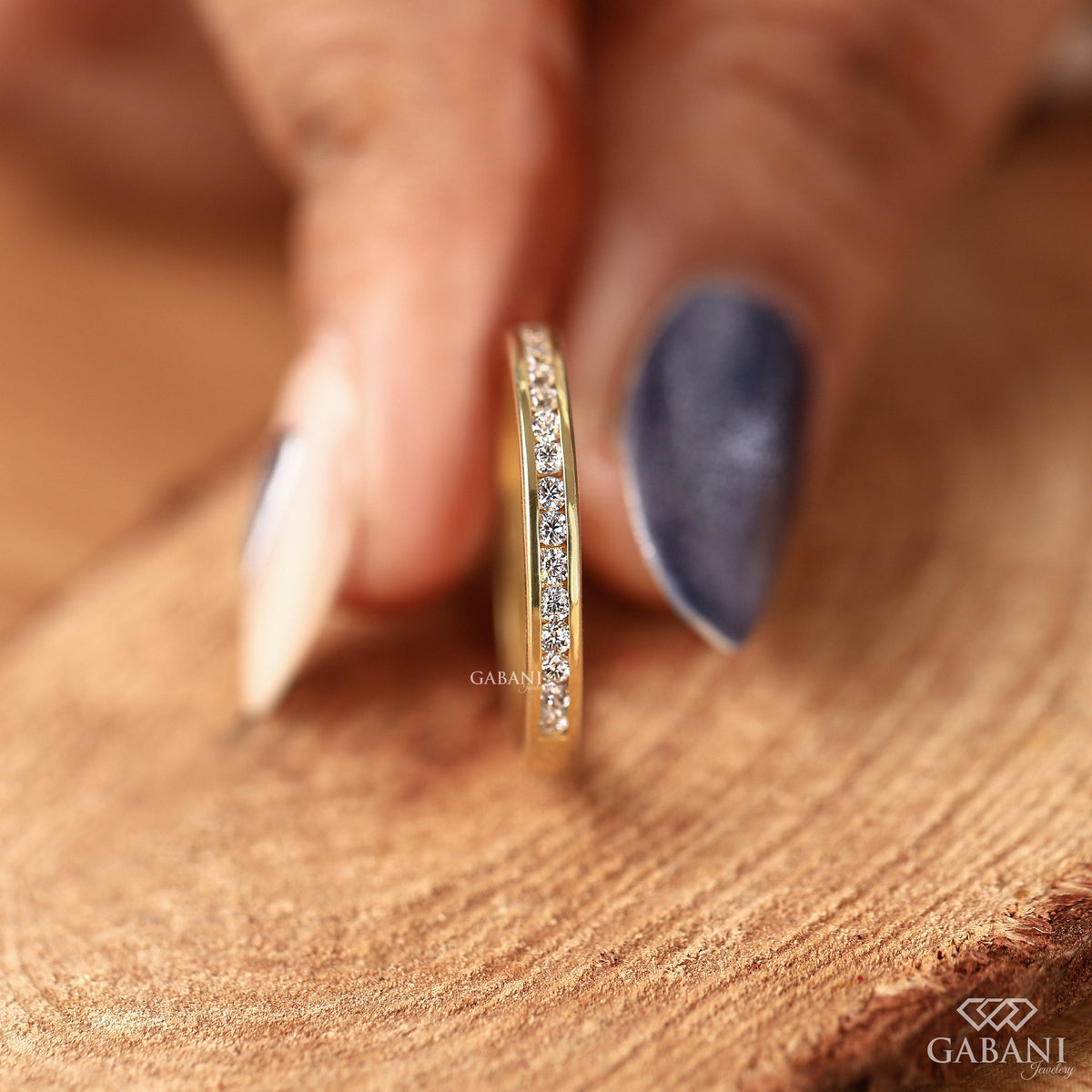 dainty channel set lab grown diamond band crafted in smooth yellow gold