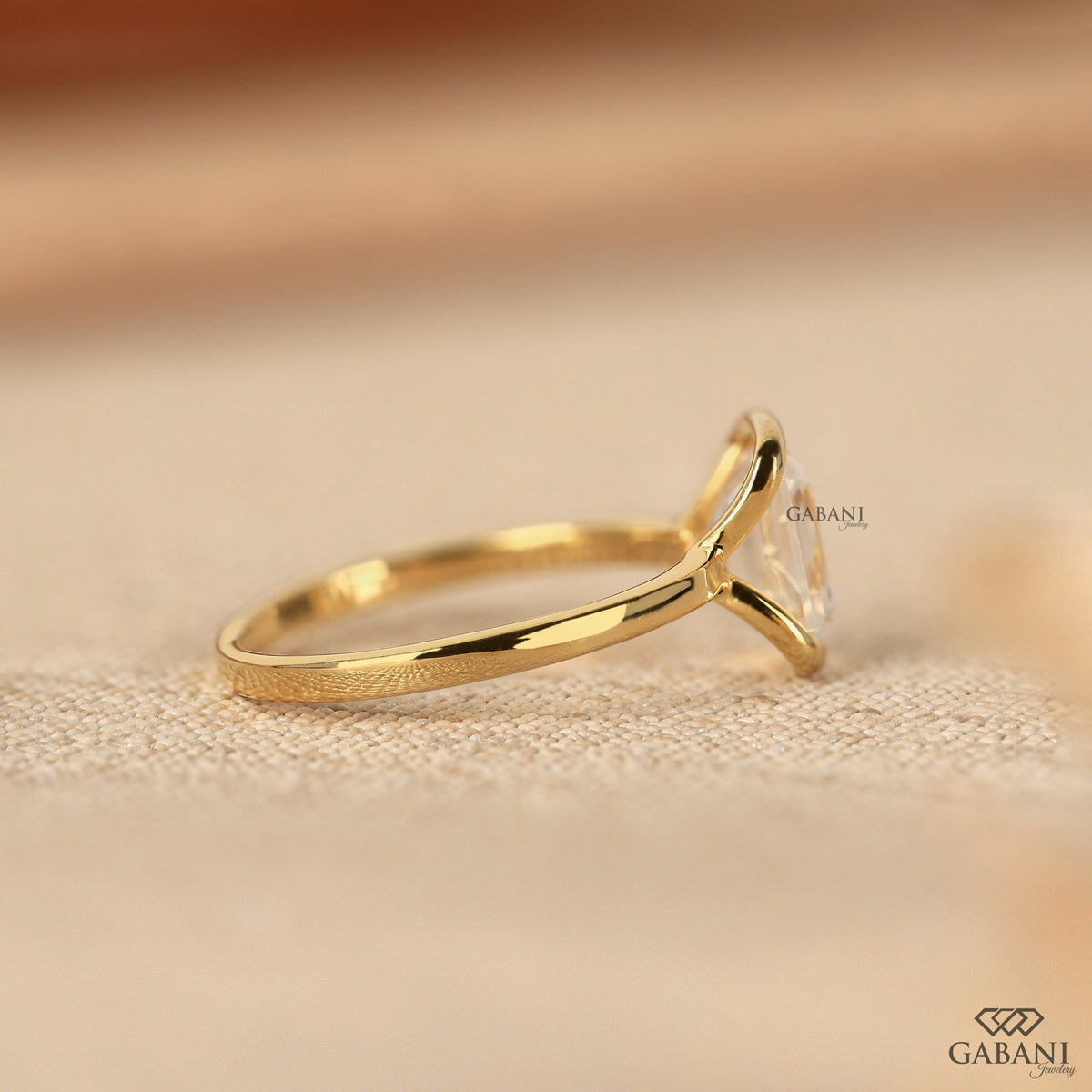 yellow gold solitaire ring with emerald cut lab grown diamond half bezel