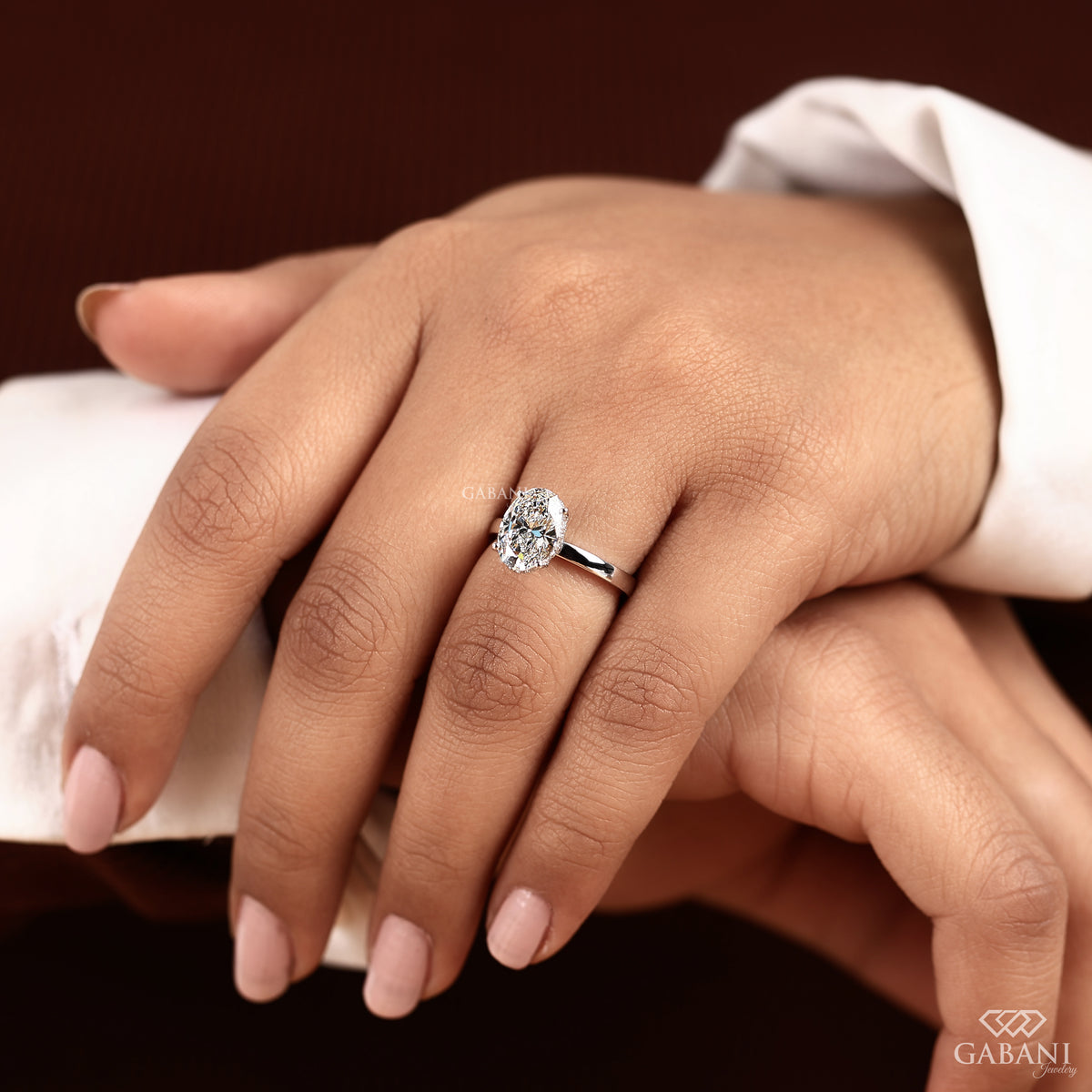 hidden halo oval diamond ring crafted in smooth white gold