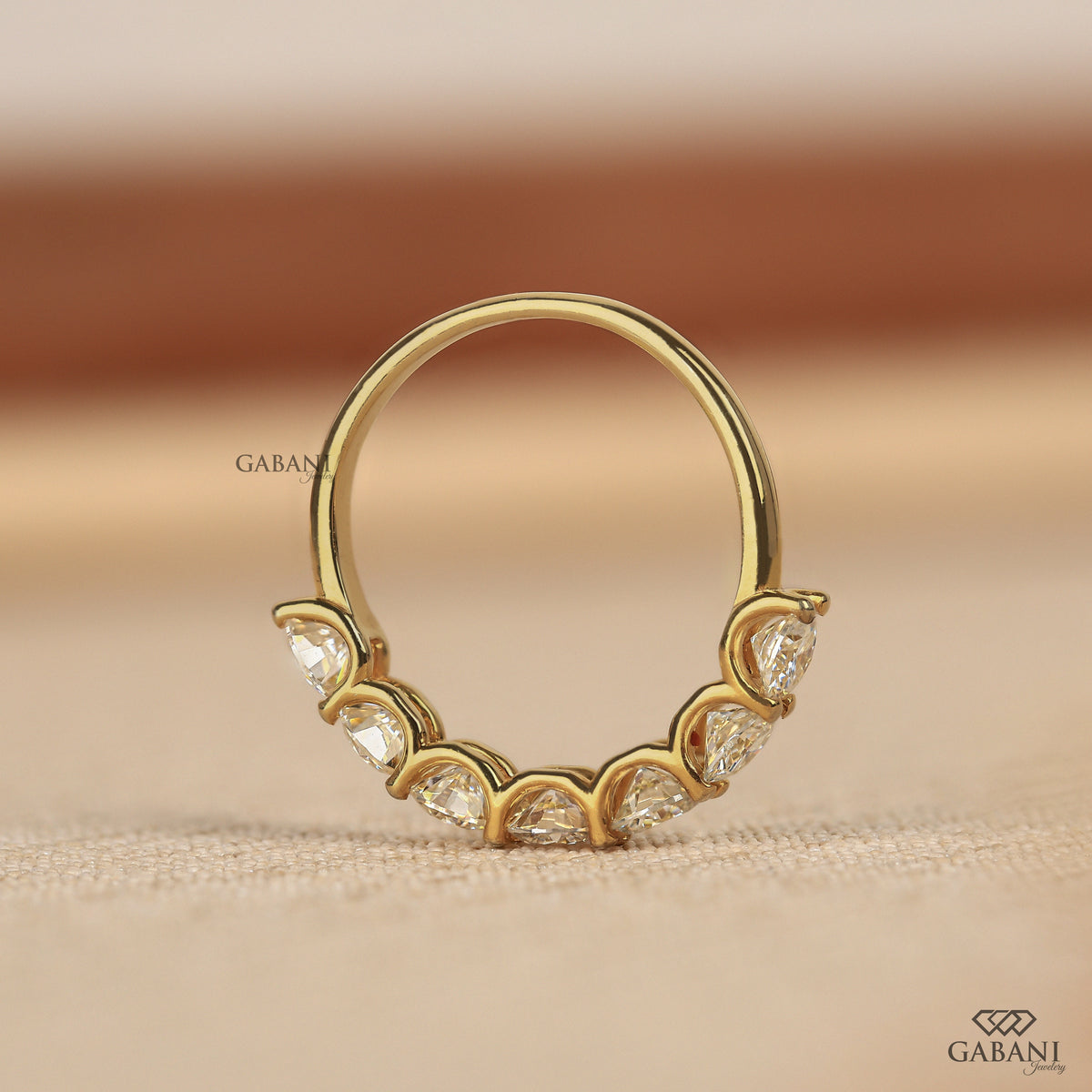 lab grown diamond wedding band with seven round cut stones set in a minimal U prong design in 14k yellow gold
