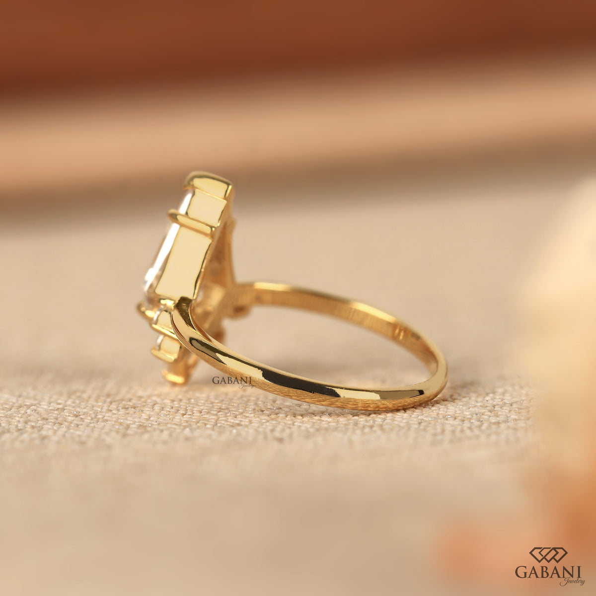 yellow gold ring with kite cut lab grown diamond and decorative side stones